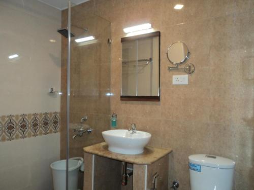 a bathroom with a sink and a shower at Mani's residency in Madurai