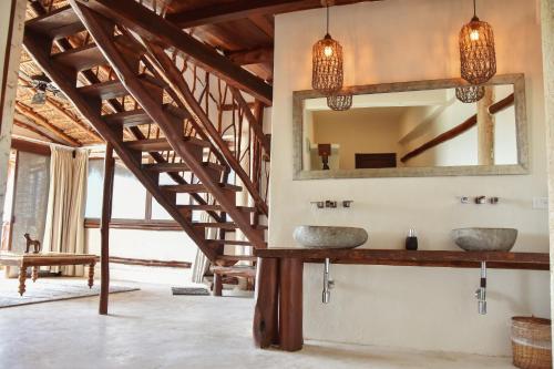 a bathroom with two sinks and a mirror at Spirit Holbox in Holbox Island