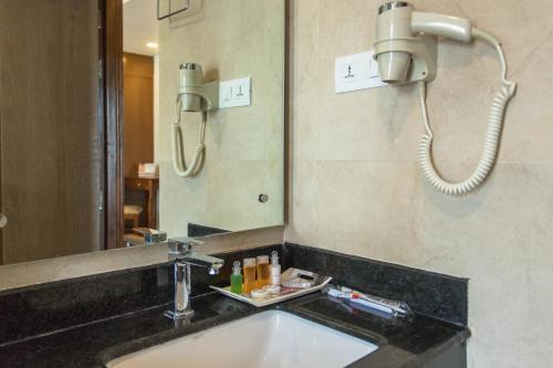 a bathroom with a sink and a mirror at Landmark Pokhara in Pokhara