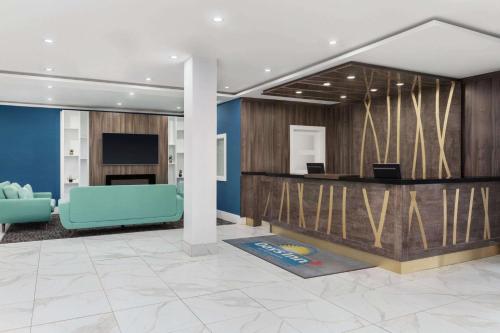 a lobby with a reception desk and a blue couch at Days Inn by Wyndham Saint John in Saint John