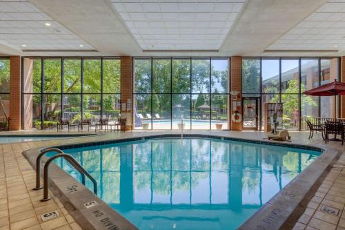 a pool in a hotel with a large room with windows at Quality Inn Exit 4 Clarksville in Clarksville