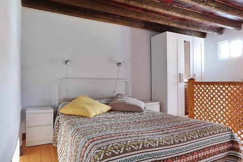 a bed with two pillows on it in a room at Cozy House 5 min from the Historic Center of Galdar in Gáldar
