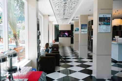 a lobby with a black and white checkered floor at Best Western Royal Buriram in Buriram