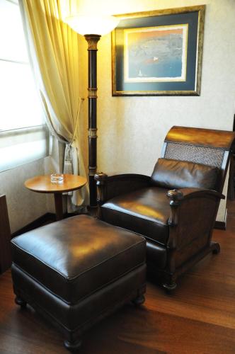 a room with two chairs and a table and a lamp at Mövenpick Hotel Izmir in Izmir