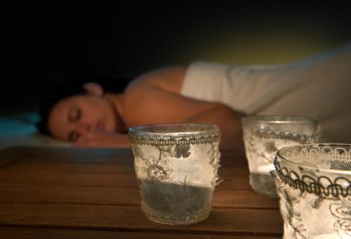 a naked man laying on a table with three glasses at Yam Suf by Isrotel Collection in Eilat