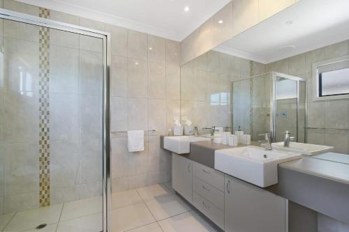 a bathroom with two sinks and a shower at Cypress Townhouse 11 in Mulwala