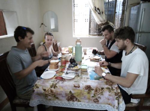 a group of people sitting around a table at JJ & JE Family House in Dar es Salaam