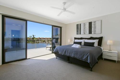 a bedroom with a bed and a large sliding glass door at Cypress Townhouse 11 in Mulwala