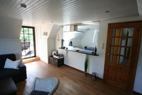 a living room with a couch and a window at De schöne Utsicht in Langholz