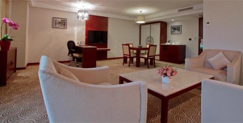 a living room with a couch and chairs and a table at Hôtel Huatian Chinagora in Alfortville