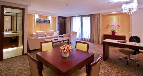 a living room with a table and a living room at Hôtel Huatian Chinagora in Alfortville