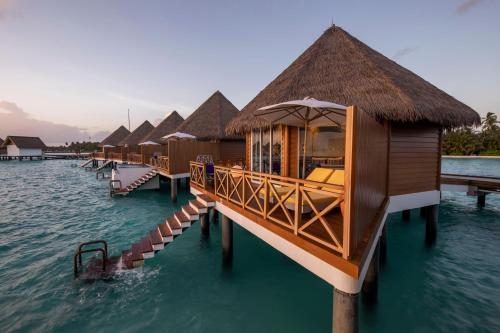 a row of huts on the water in the ocean at Mercure Maldives Kooddoo - Adults - Only Escape - 50 percent off Transfers in Gaafu Alifu Atoll