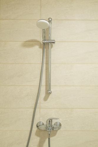 a shower with a shower head in a bathroom at ZIP Apartments in Mamaia