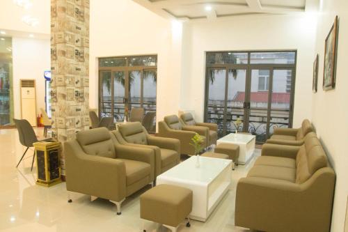 a waiting room with couches and chairs and a table at Khách sạn Hậu Giang in Vị Thanh