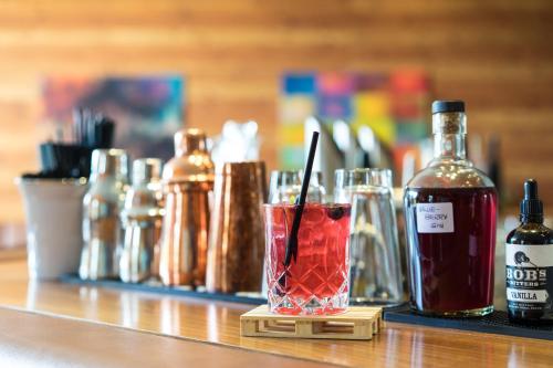 a drink in a glass on a counter with bottles at NIDUM - Casual Luxury Hotel in Seefeld in Tirol