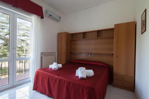 a bedroom with a bed with two towels on it at Hotel Nella in La Spezia