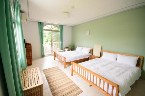 Kama o mga kama sa kuwarto sa Green 58 B&B