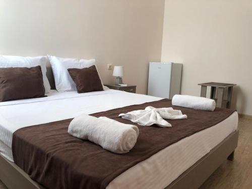 a large bed with towels on top of it at Guesthouse Family in Batumi