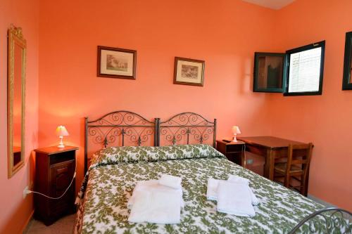 a bedroom with a bed with two towels on it at Agriturismo Santa Chiara in Alezio
