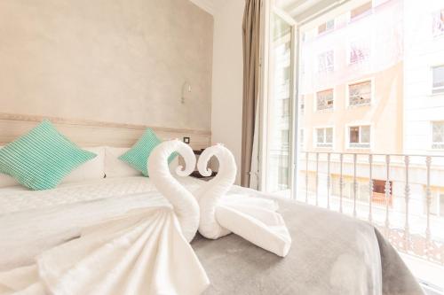two swans are sitting on a bed in a bedroom at Hostal Pio Centro in Madrid