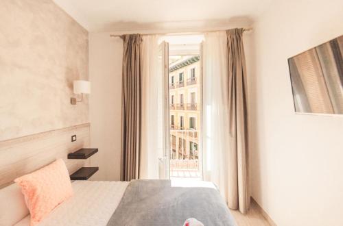 A bed or beds in a room at Hostal Pio Centro