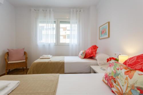 a white room with two beds and a couch at Casa Ros-PLAYA free parking by Cadiz4Rentals in Cádiz