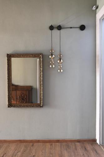 an empty room with a mirror and a chandelier at Agora Residence in Chios