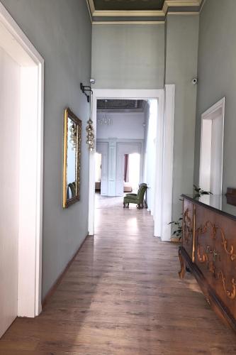 an empty hallway with a wood floor and a mirror at Agora Residence in Chios