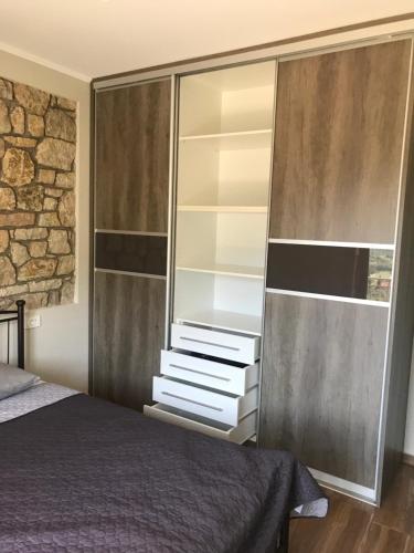 a bedroom with a bed and a large closet at Panoraia Maisons in Margariti