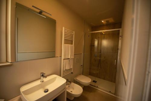 a bathroom with a sink and a toilet and a shower at Michelino House in Parghelia
