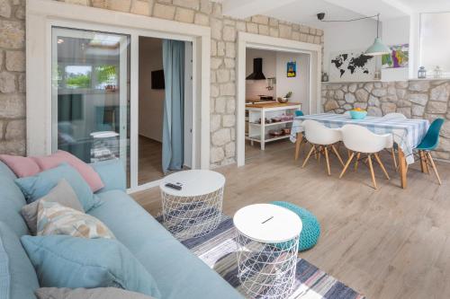 a living room with a blue couch and a table at Apartments Nika in Crikvenica