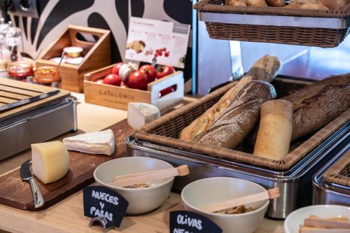 a display of bread and other foods on a counter at Catalonia Sabadell in Sabadell