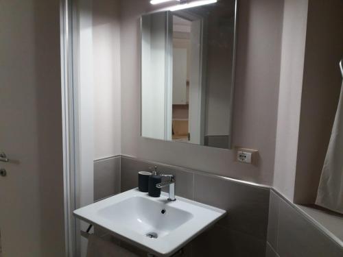 a bathroom with a white sink and a mirror at B&B Isola Verde in Villa