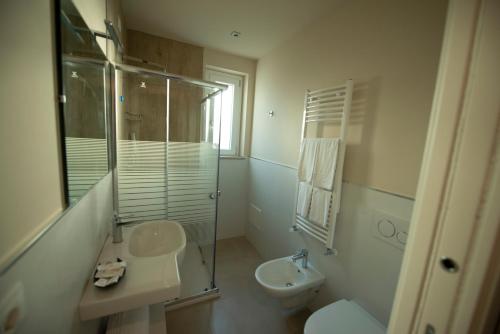 a bathroom with a sink and a toilet and a shower at Michelino House in Parghelia