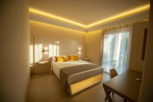 a bedroom with a bed with yellow pillows and a window at Michelino House in Parghelia