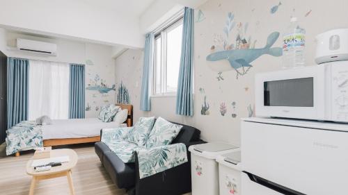 a small living room with a couch and a tv at AFP Tennoji Apartment in Osaka