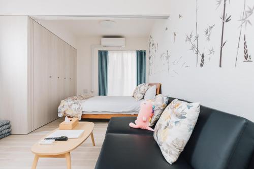 a living room with a couch and a bed at AFP Tennoji Apartment in Osaka