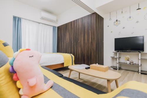 a hotel room with a couch and a tv at AFP Tennoji Apartment in Osaka