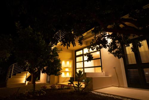 a house lit up at night with a window at Michelino House in Parghelia
