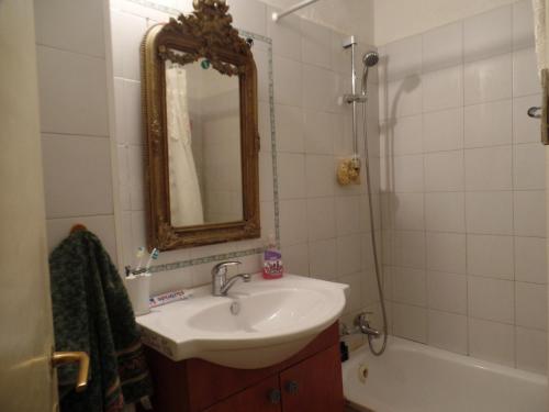 a bathroom with a sink and a mirror and a tub at Cozy Garden in Jerusalem