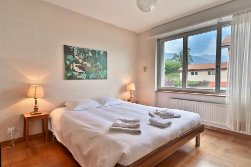 - une chambre avec un lit, deux lampes et une fenêtre dans l'établissement Maison familiale à Montreux avec vue sur le lac, à Montreux