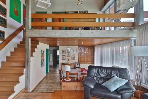 a living room with a couch and a staircase at Maison familiale à Montreux avec vue sur le lac in Montreux