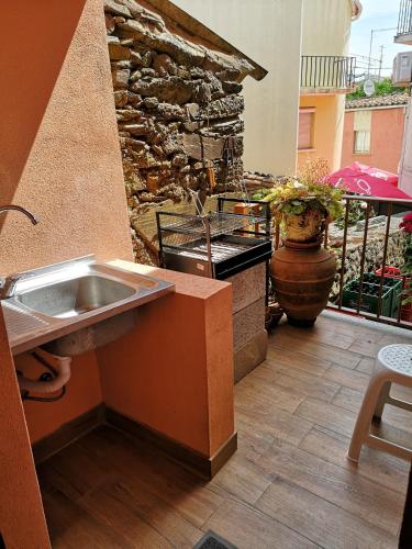a outdoor kitchen with a sink and a stone wall at CASA TITA in Lavacolhos