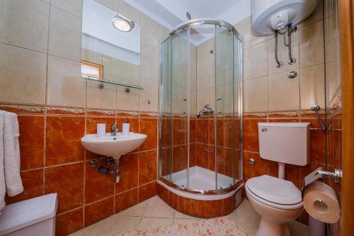 a bathroom with a shower and a toilet and a sink at Villa Milena in Trogir