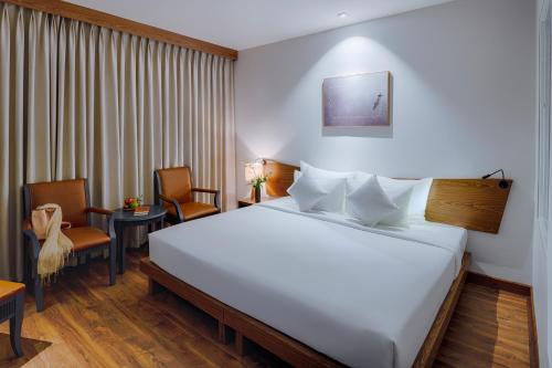 Ένα ή περισσότερα κρεβάτια σε δωμάτιο στο Silverland Min Hotel