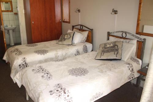 En eller flere senger på et rom på Pamy Guest Lodge