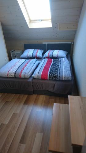 a bed with pillows on it in a room at Agroturystyka Piekielnik in Piekielnik