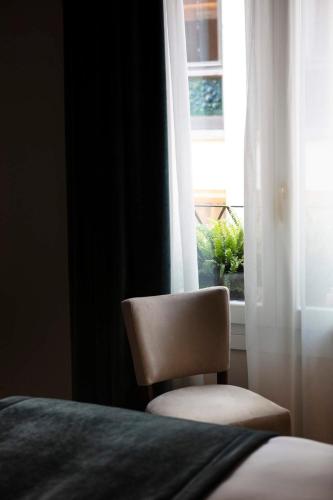 a chair sitting in front of a window at Residenza Ducato in Venice