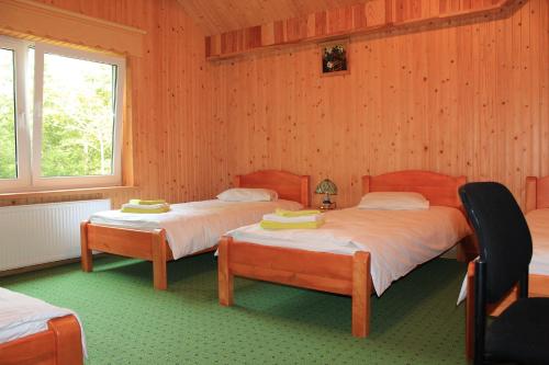 a bedroom with two beds and a window at Imantas nams in Jūrkalne