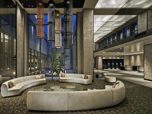 a lobby of a building with couches at Hotel Vischio Kyoto by GRANVIA in Kyoto